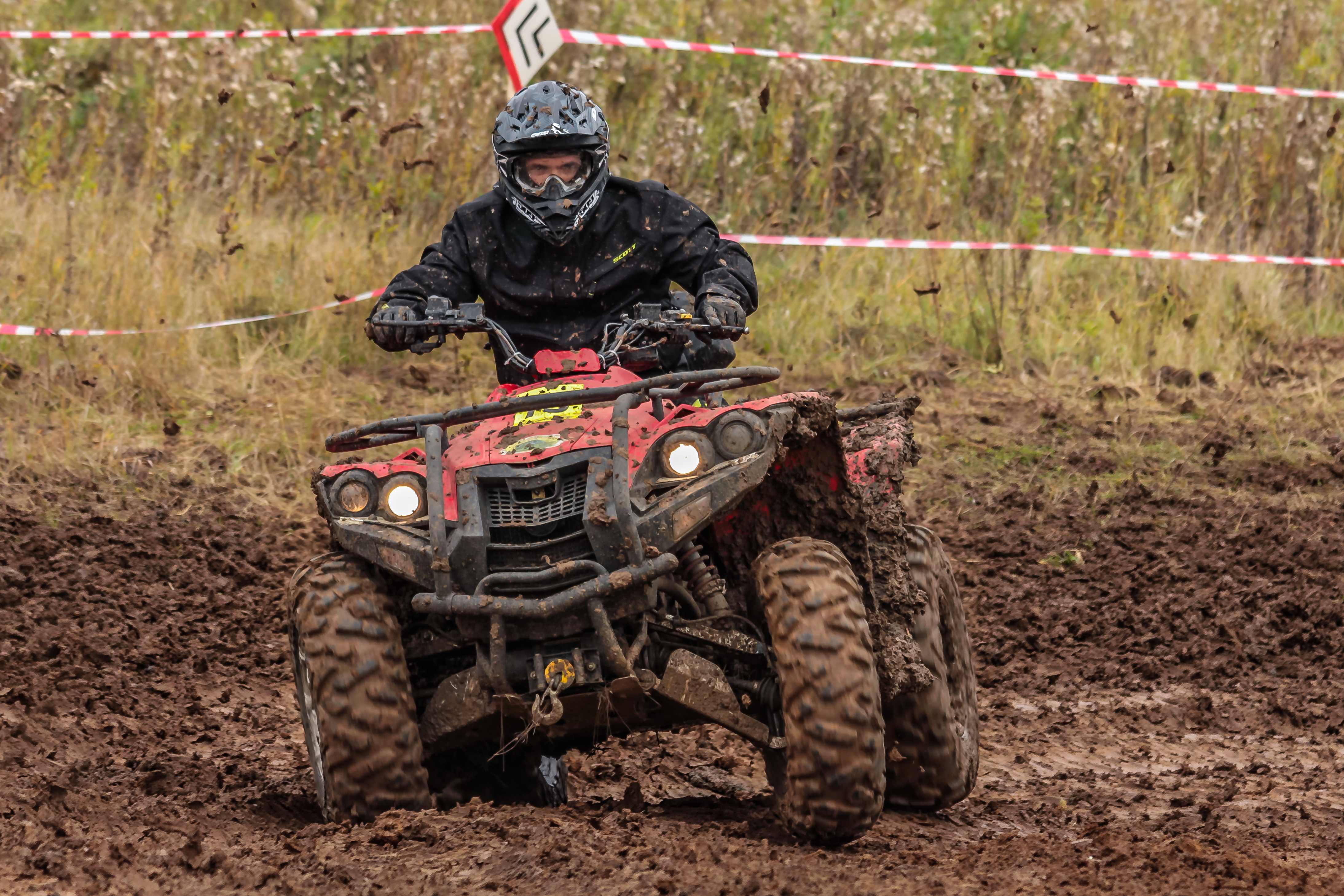 man riding atv in the mud